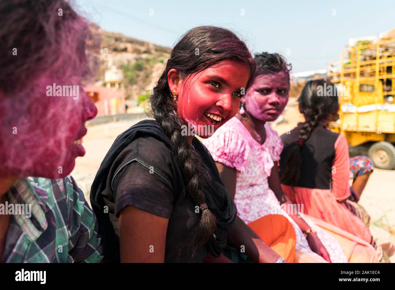 Hampi, India - April 07, 2019: Young indian girls painted in pink pigments celebrating Holy Festival in rural village in Hanuman Halli, Karnataka, India Stock Photo