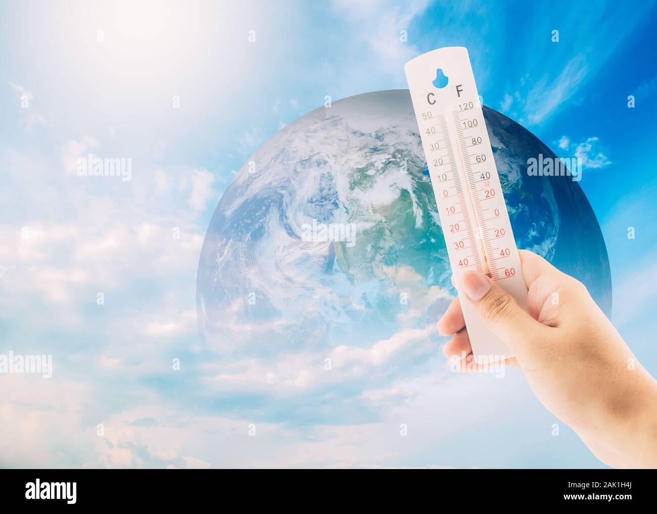 Thermometer check the earth's temperature with impact of global