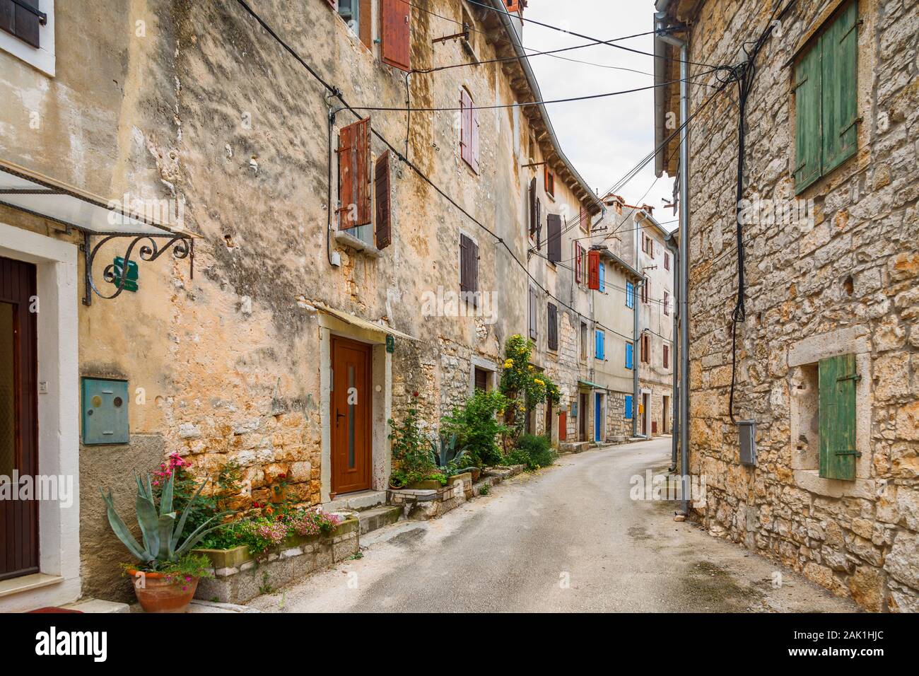 Typical street view of terraced houses with shutters in the historic old town in Bale, a small hill town on Mont Perin in Istria County, Croatia Stock Photo