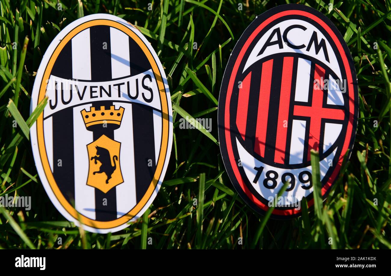 September 6, 2019, Turin, Italy. Emblems of Italian football clubs Juventus Turin and Milan on the green grass of the lawn. Stock Photo
