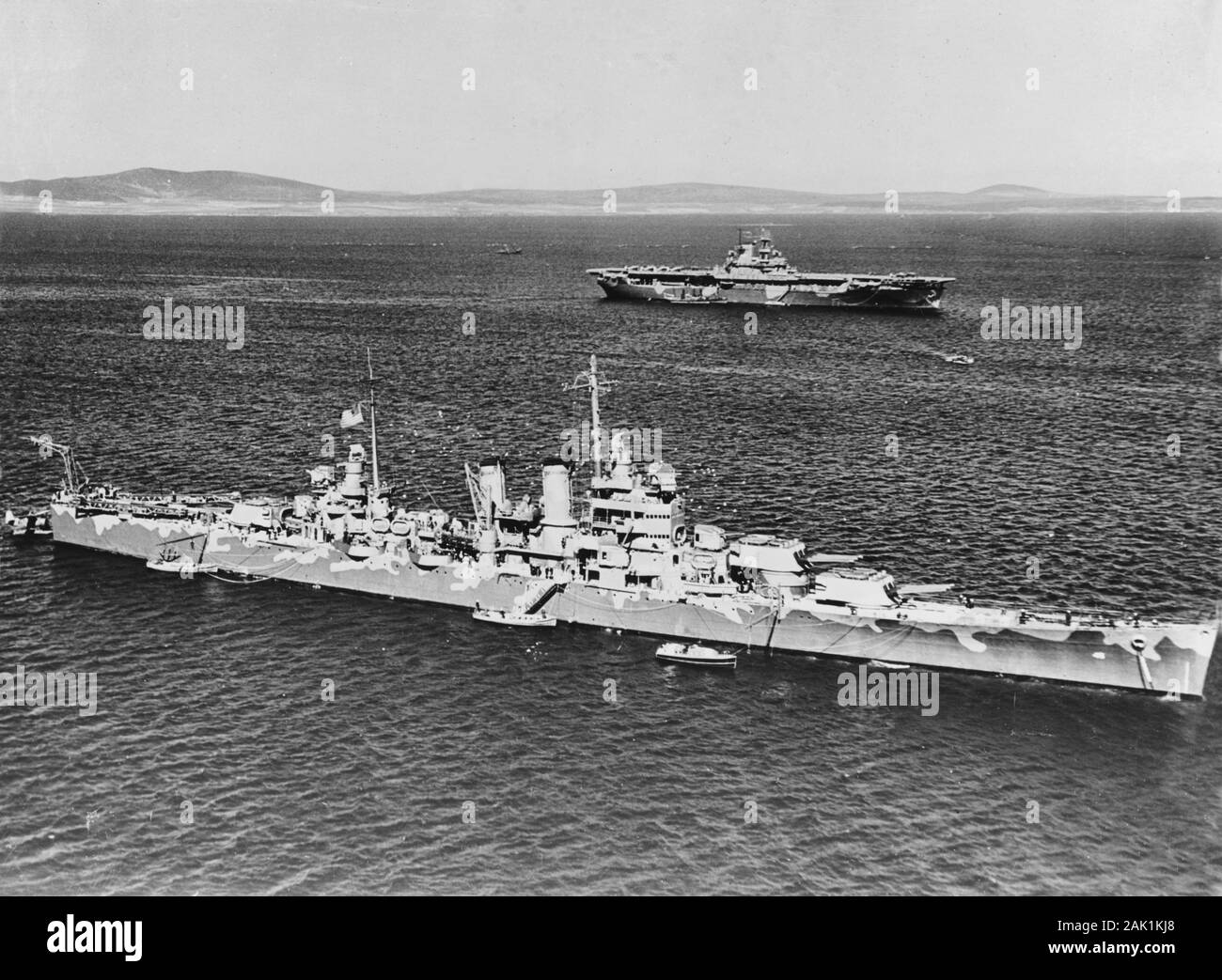 The U.S. Navy heavy cruiser USS Wichita (CA-45) at anchor in Scapa Flow, Scotland (UK), in April 1942. The aircraft carrier USS Wasp (CV-7) is in the background. Stock Photo