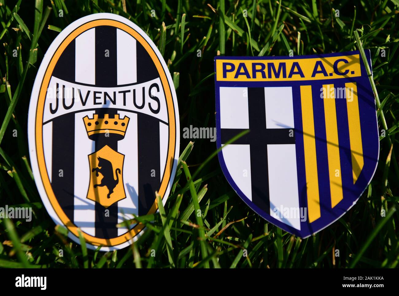 September 6, 2019, Turin, Italy. Emblems of Italian football clubs Juventus Turin and Parma on the green grass of the lawn. Stock Photo