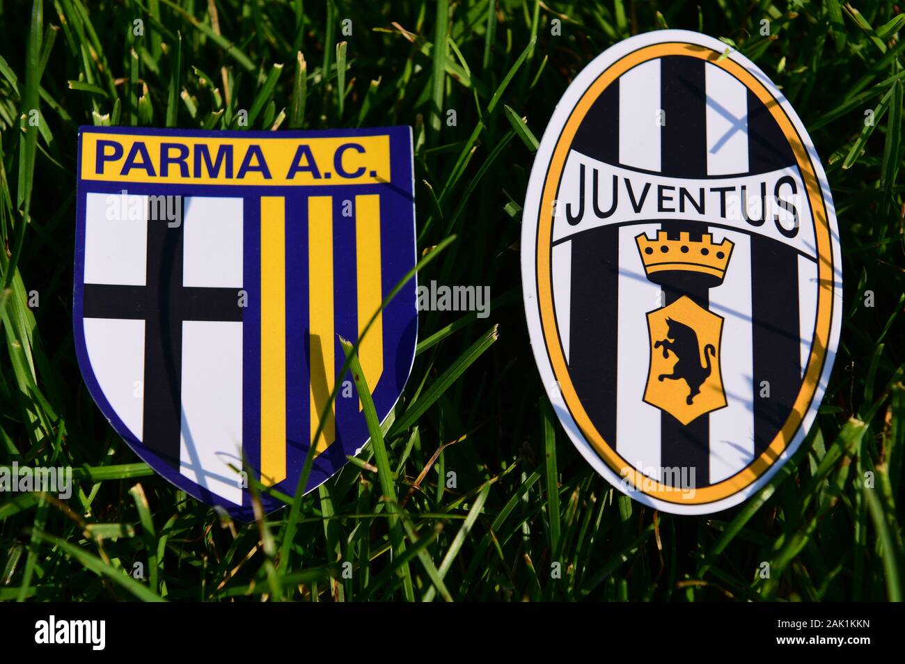 September 6, 2019, Turin, Italy. Emblems of Italian football clubs Juventus Turin and Parma on the green grass of the lawn. Stock Photo