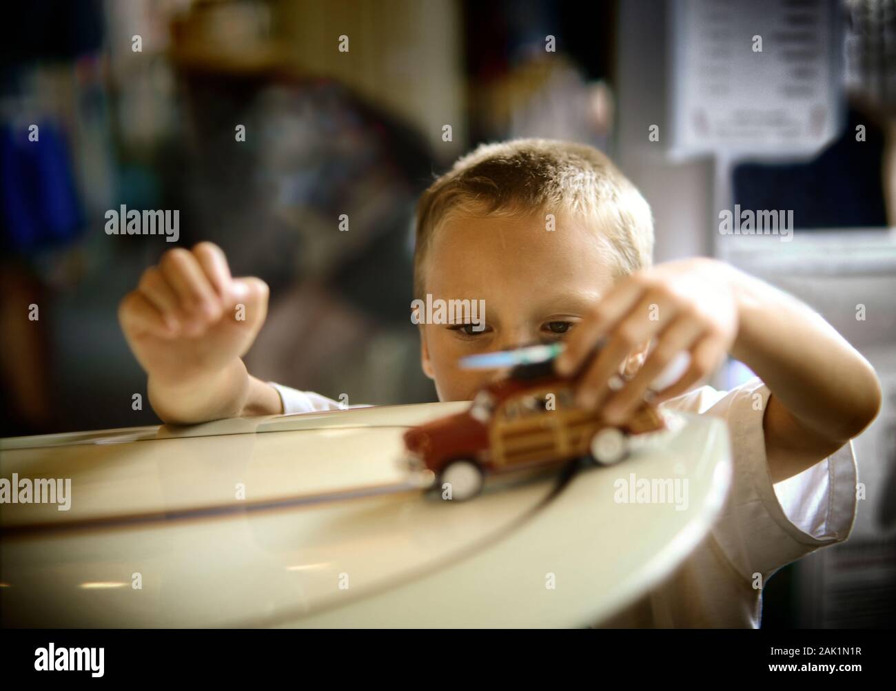 Young boy playing with toy car Stock Photo - Alamy