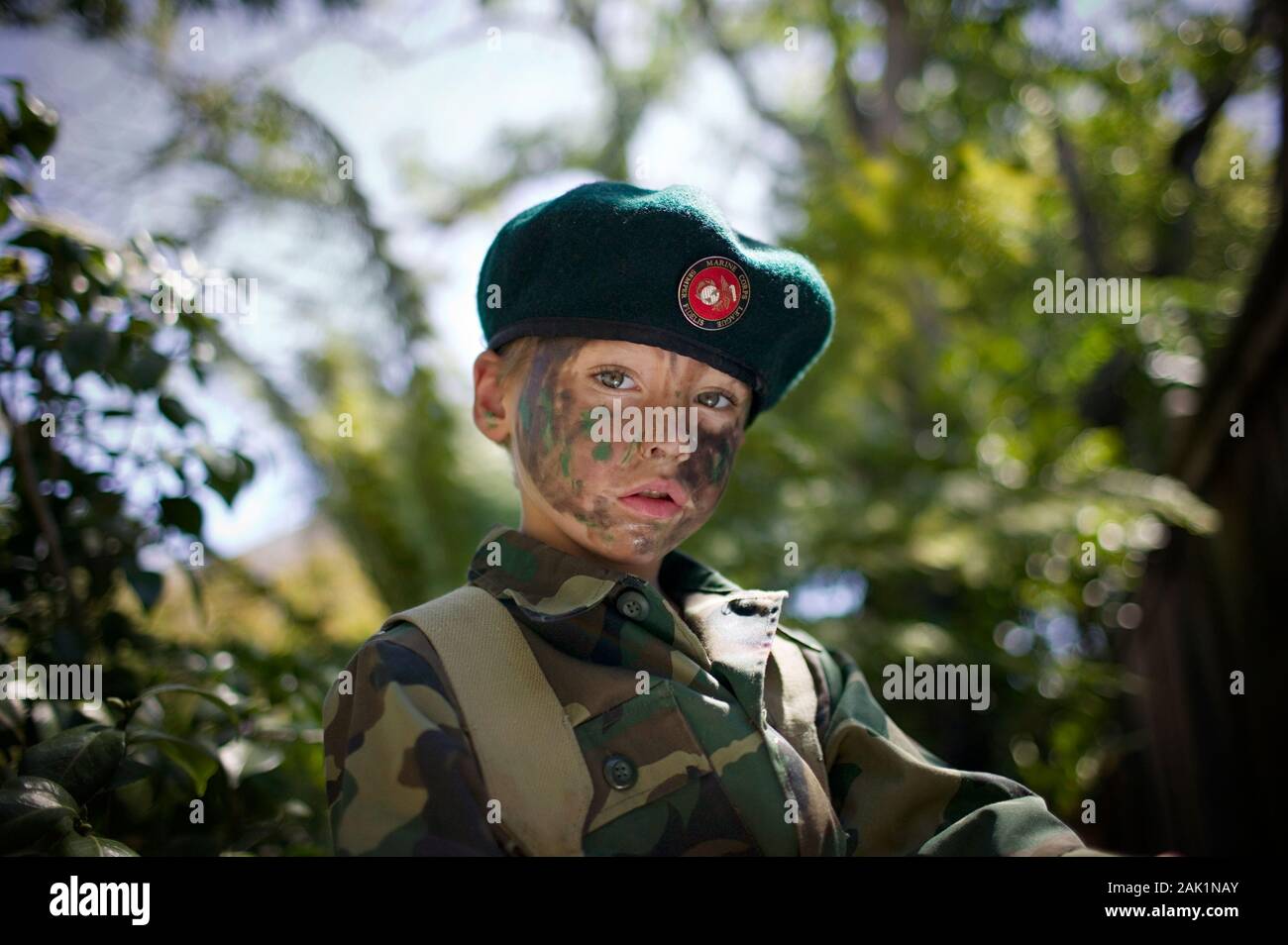 Young boy wearing a green beret and camouflage clothing Stock Photo Alamy
