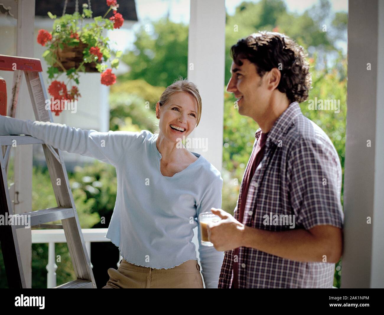 Young Couple Laughing On The Front Porch Of Their House Stock Photo Alamy young-couple-laughing-on-the-front-porch-of-their-house-stock-photo-alamy
