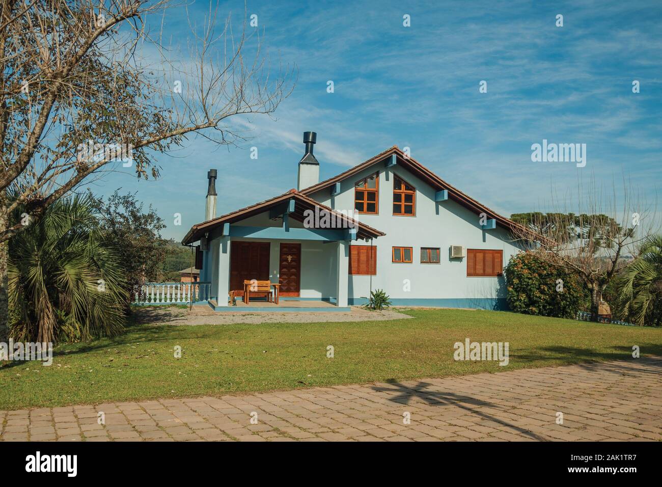 Modern country house with pathway and a lush garden in a rural ...