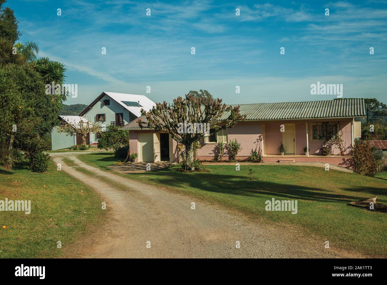 Modern country house with pathway and a lush garden in a rural ...