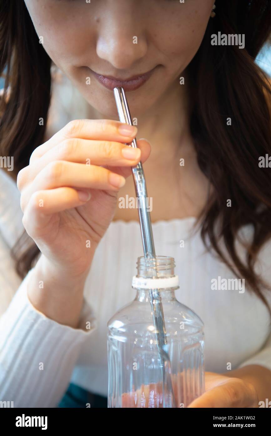Reusable straw and plastic bottle Stock Photo
