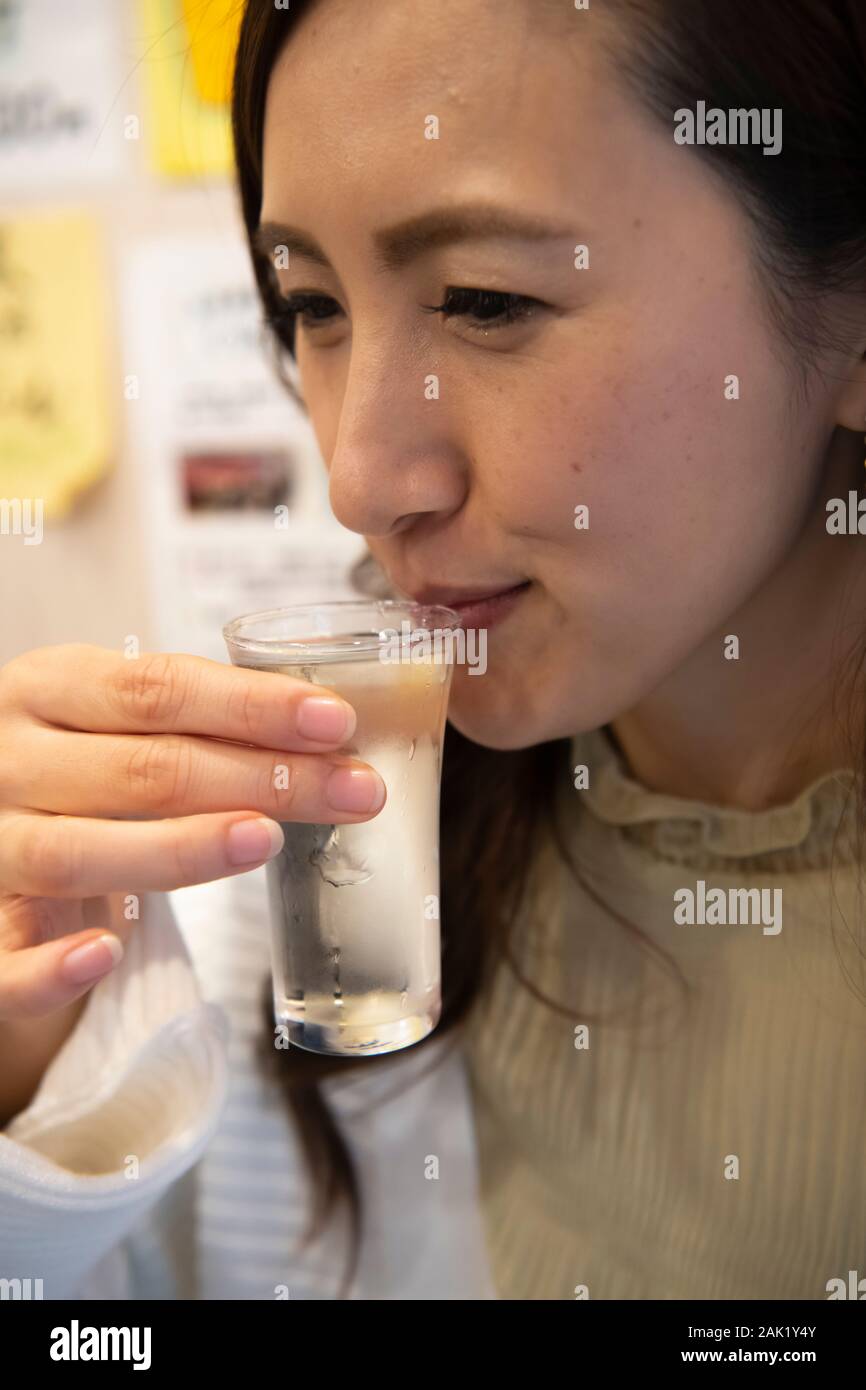 Women drinking Japanese sake in standing bar Stock Photo - Alamy