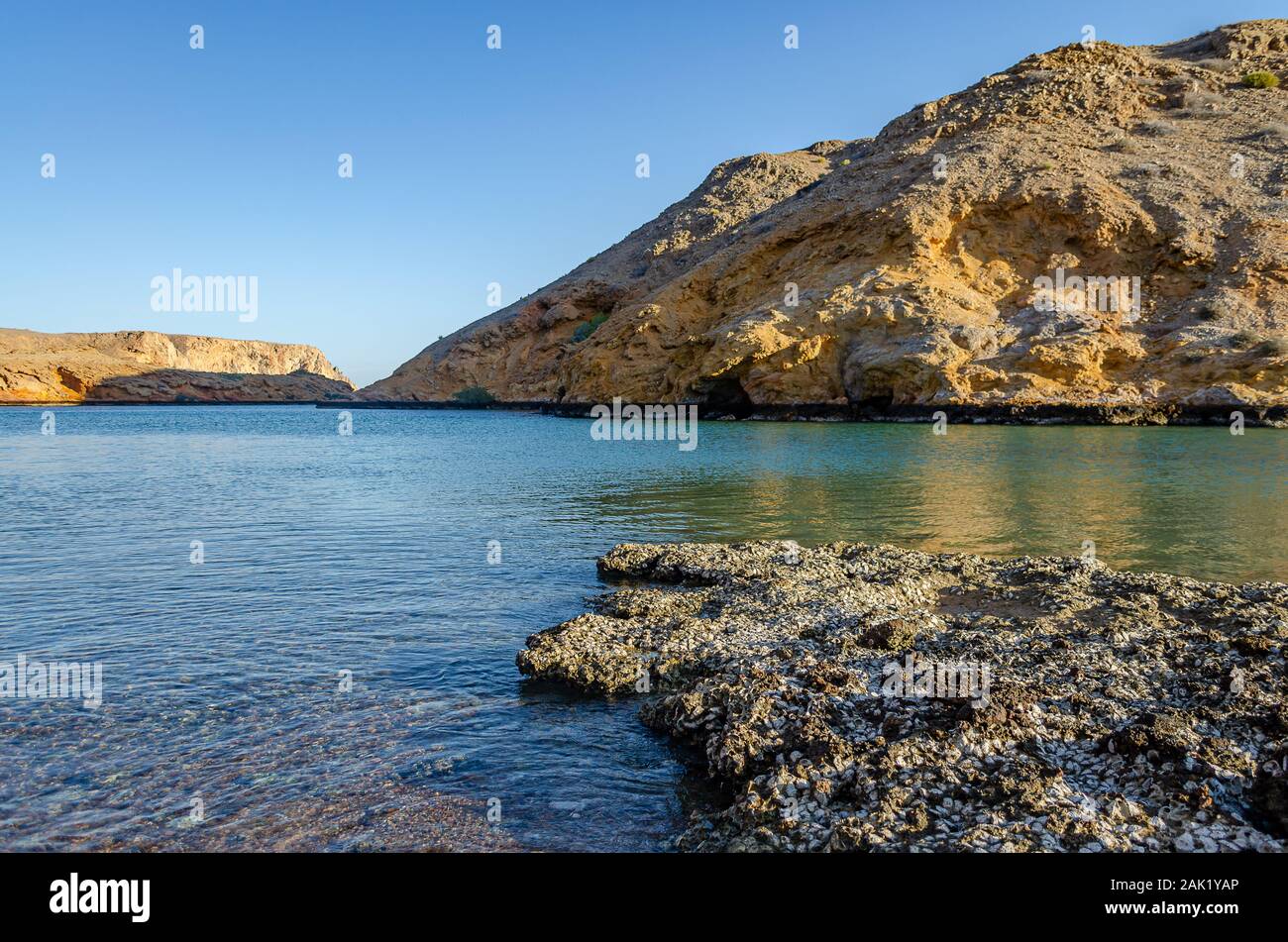 Mind refreshing view of a peaceful, rocky beach in Muscat, Oman. Ideal for meditation. Stock Photo