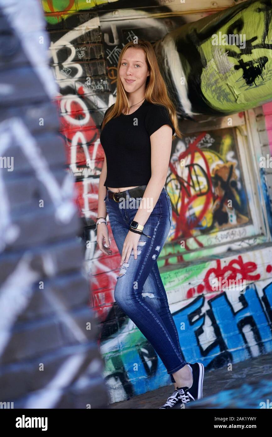 A teenage girl strikes a pose in an urban setting. Stock Photo