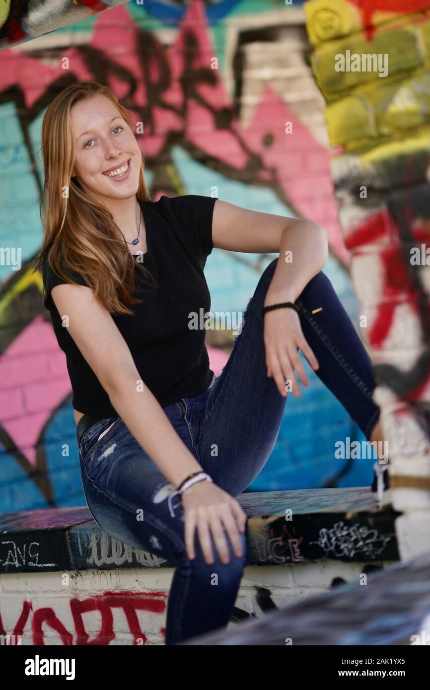 A teenage girl strikes a pose in an urban setting. Stock Photo