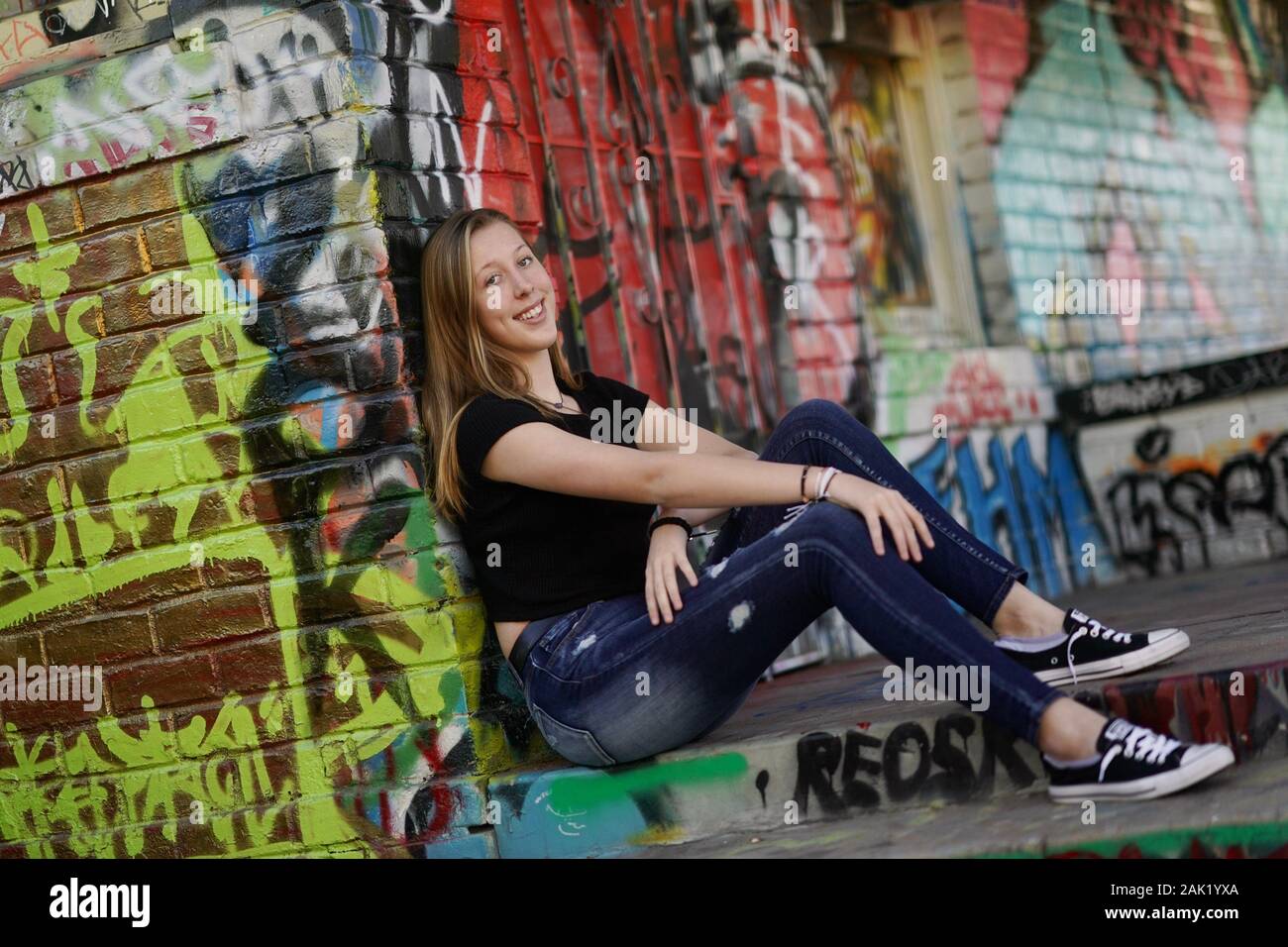 A teenage girl strikes a pose in an urban setting. Stock Photo