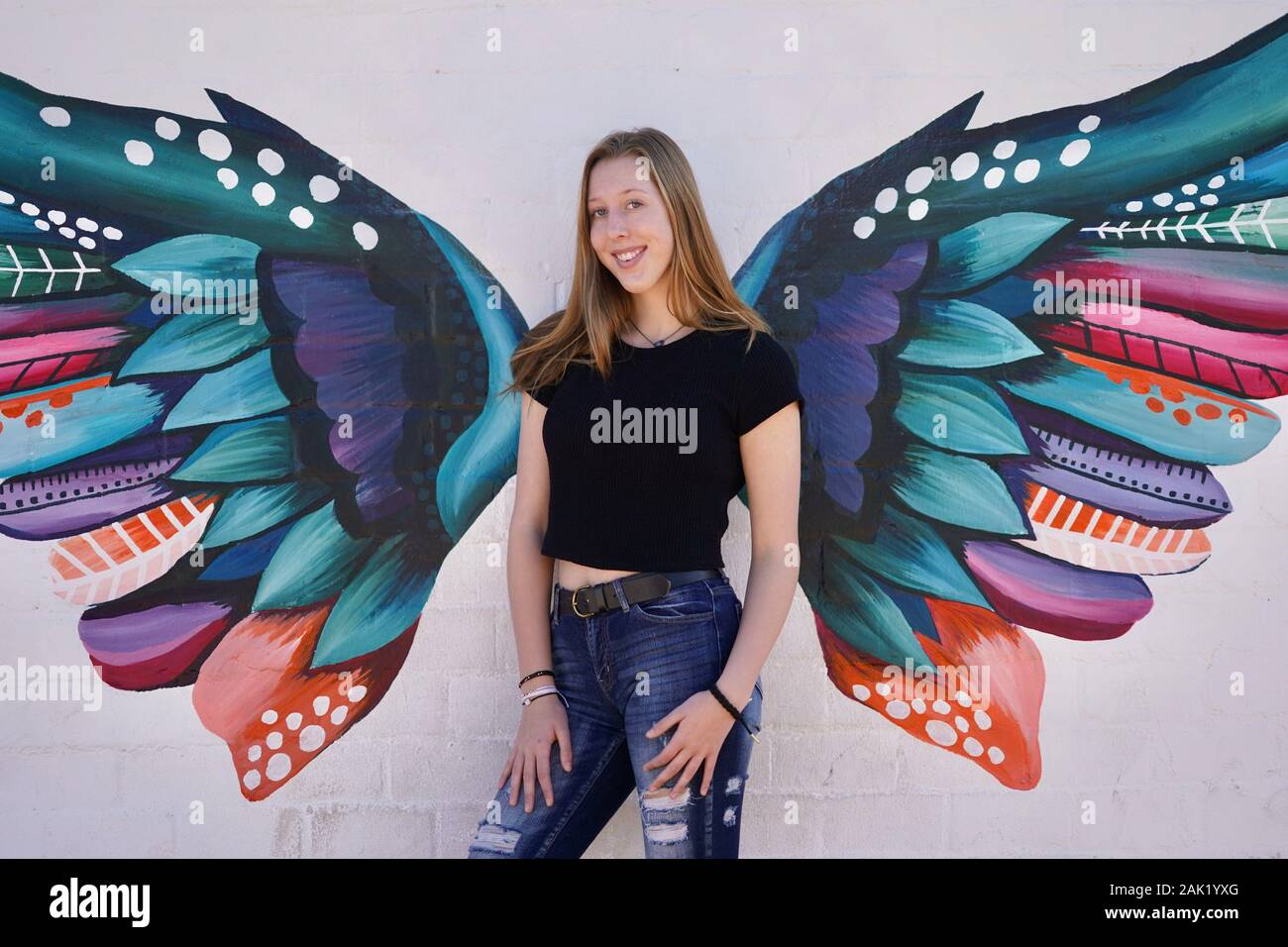 A teenage girl strikes a pose in an urban setting. Stock Photo