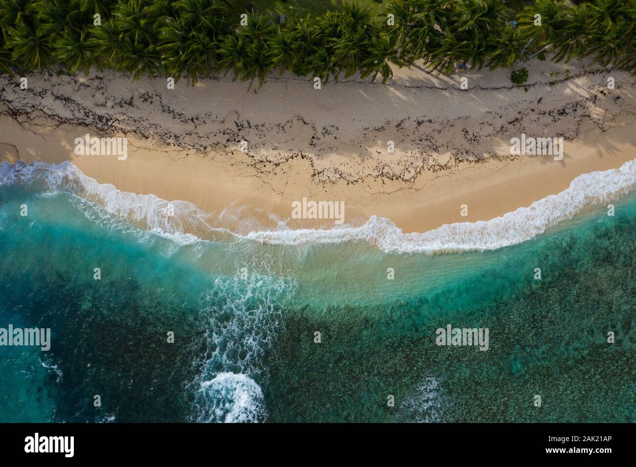 Aerial overhead view taken with  a drone of waves breaking onto Pacifico Beach Siargao,Philippines Stock Photo