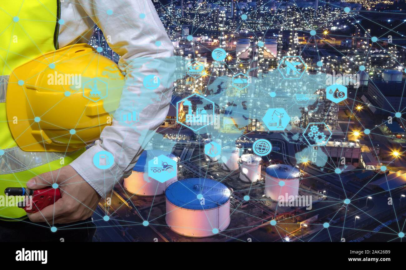 Engineer holding walkie talkie are working order at oil and gas refinery. Industry petrochemical concept image and icon connecting networking using te Stock Photo