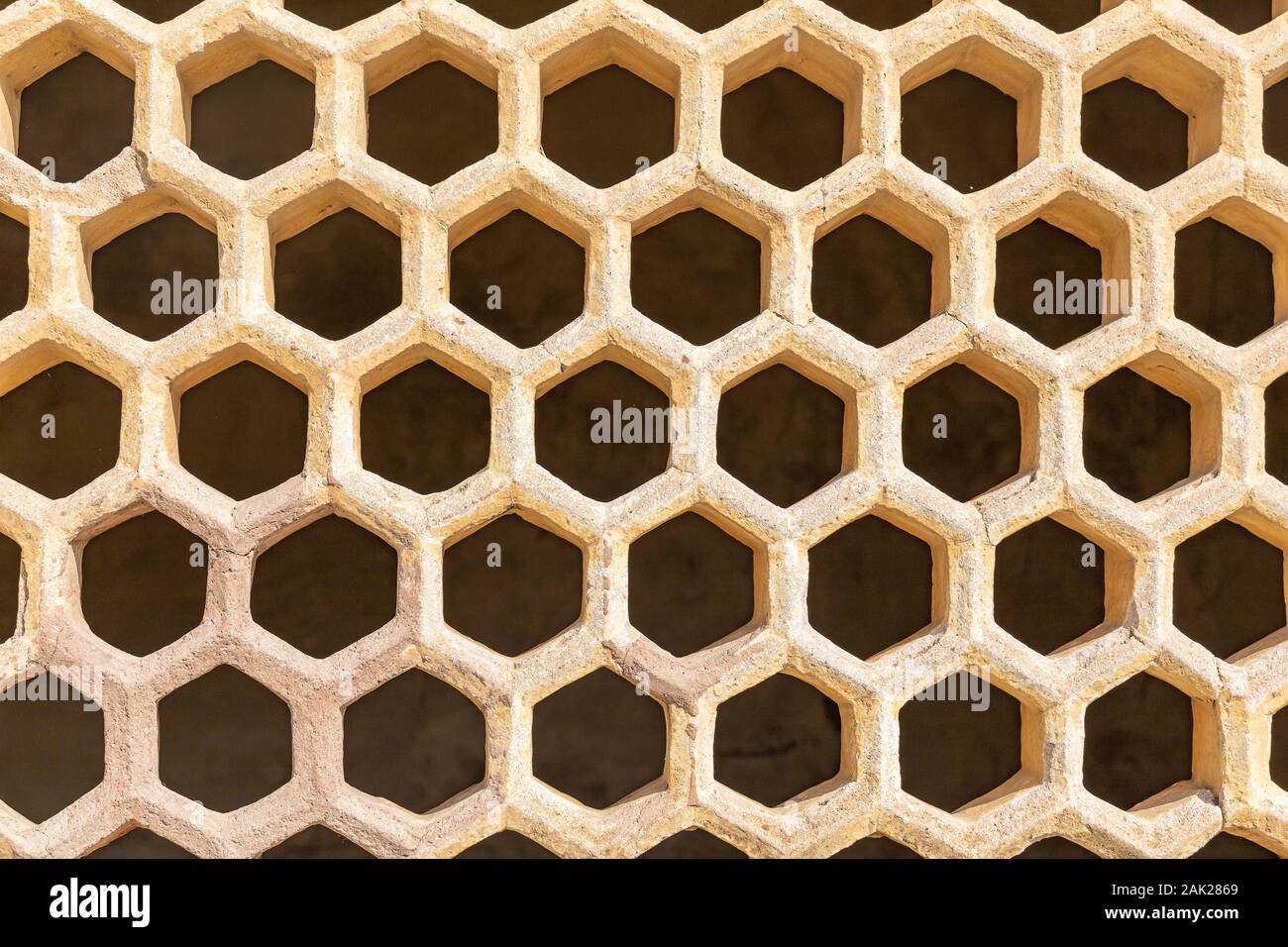Yellow color ventilated bricks wall background and texture. Stock Photo