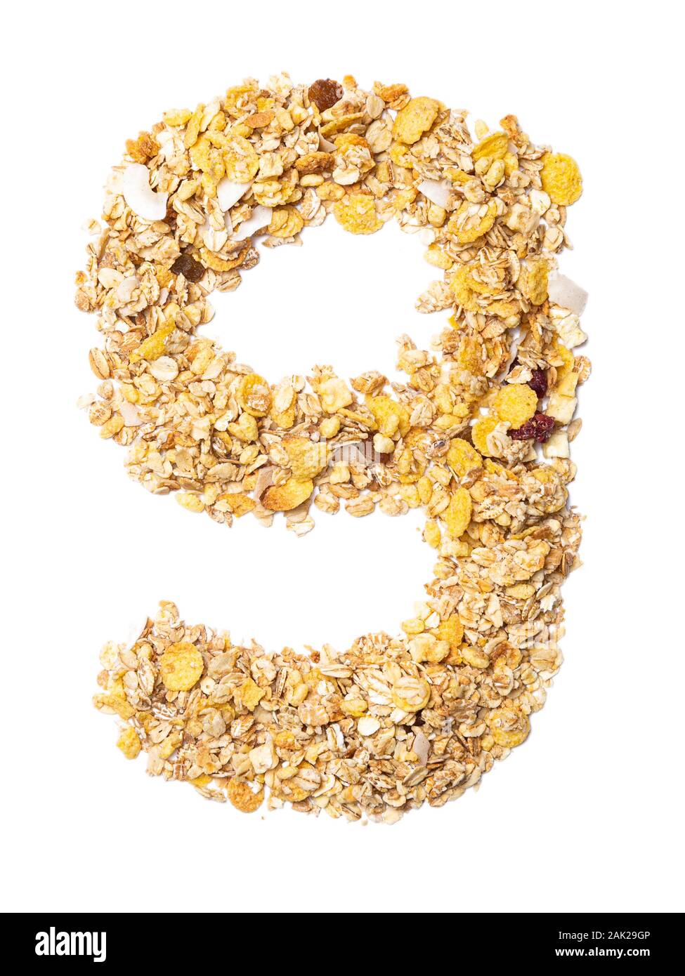 Arabic numeral "9"   from muesli with coconut, berries, raisins, cereal and natural cereals  on a white isolated background. Food pattern made from gr Stock Photo