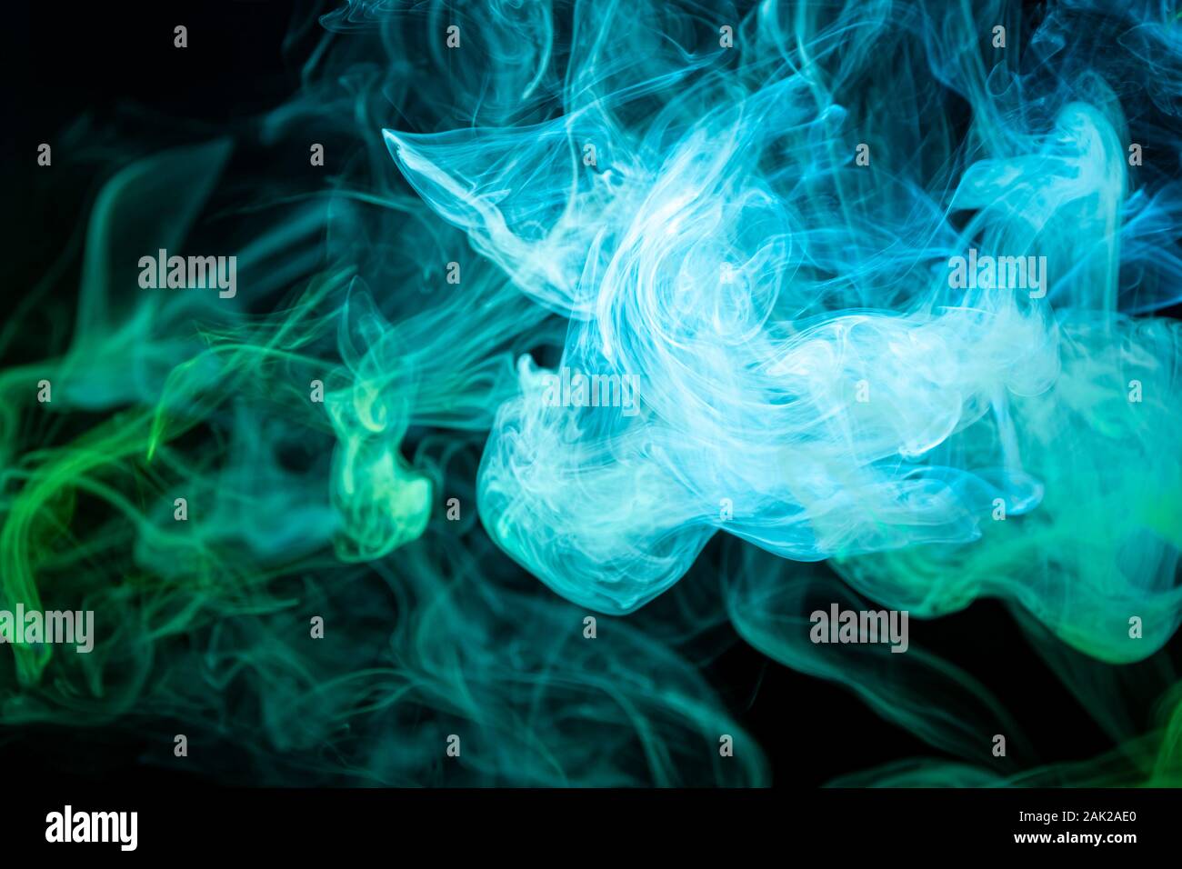 Abstract art colored blue and green smoke on black isolated background ...