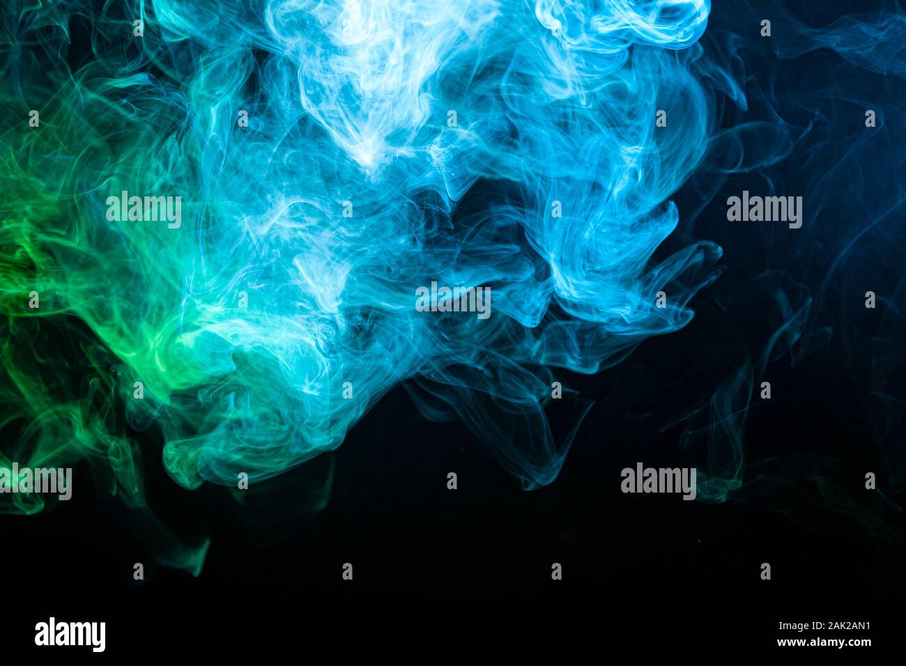 Abstract art colored blue and green smoke on black isolated background ...