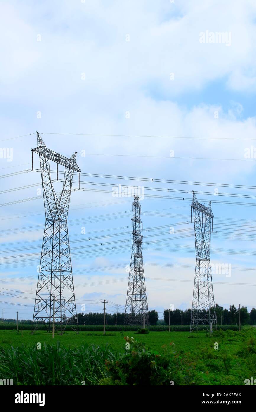 High voltage towers, under the blue sky white cloud Stock Photo - Alamy