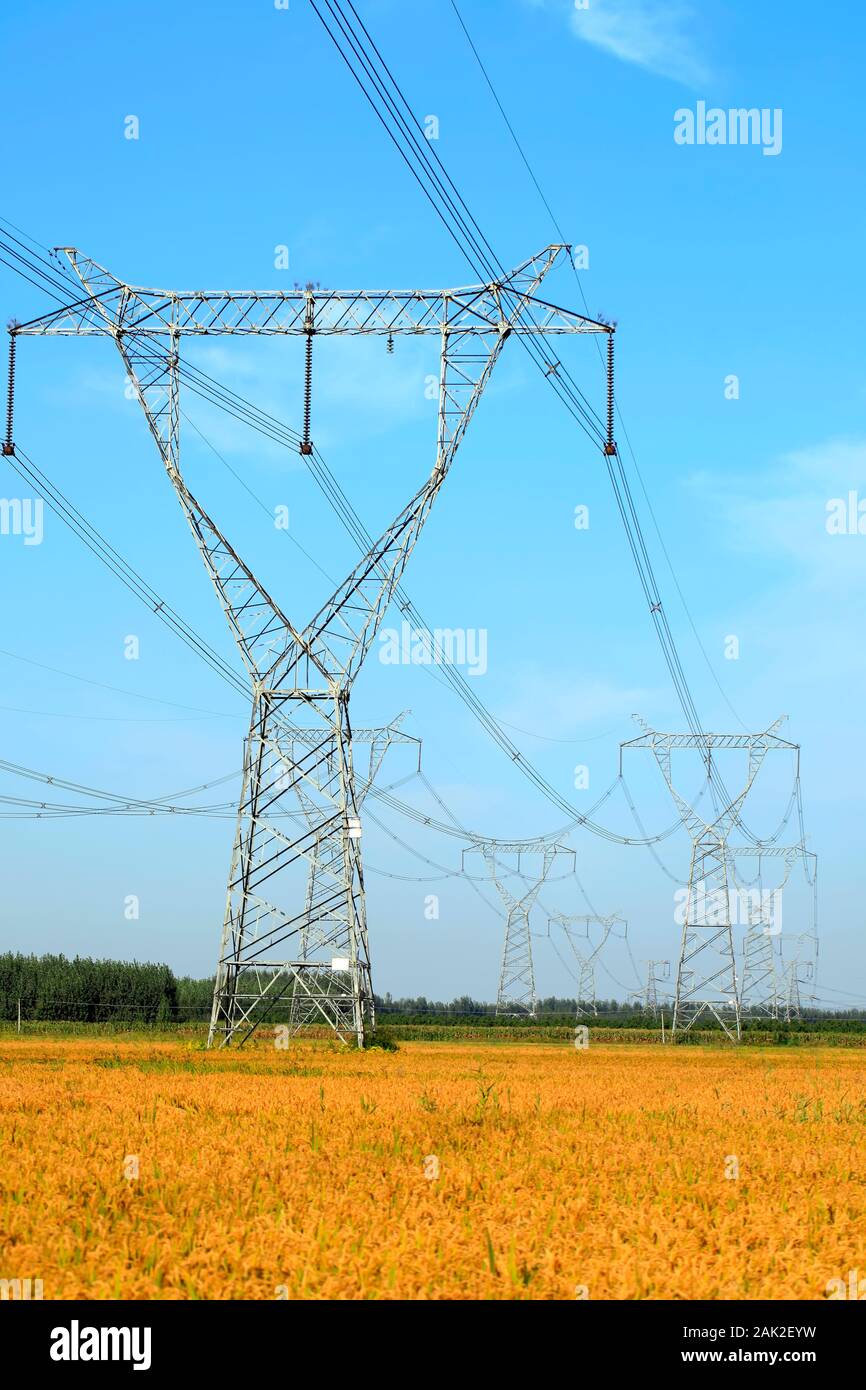 High voltage towers, under the blue sky white cloud Stock Photo - Alamy