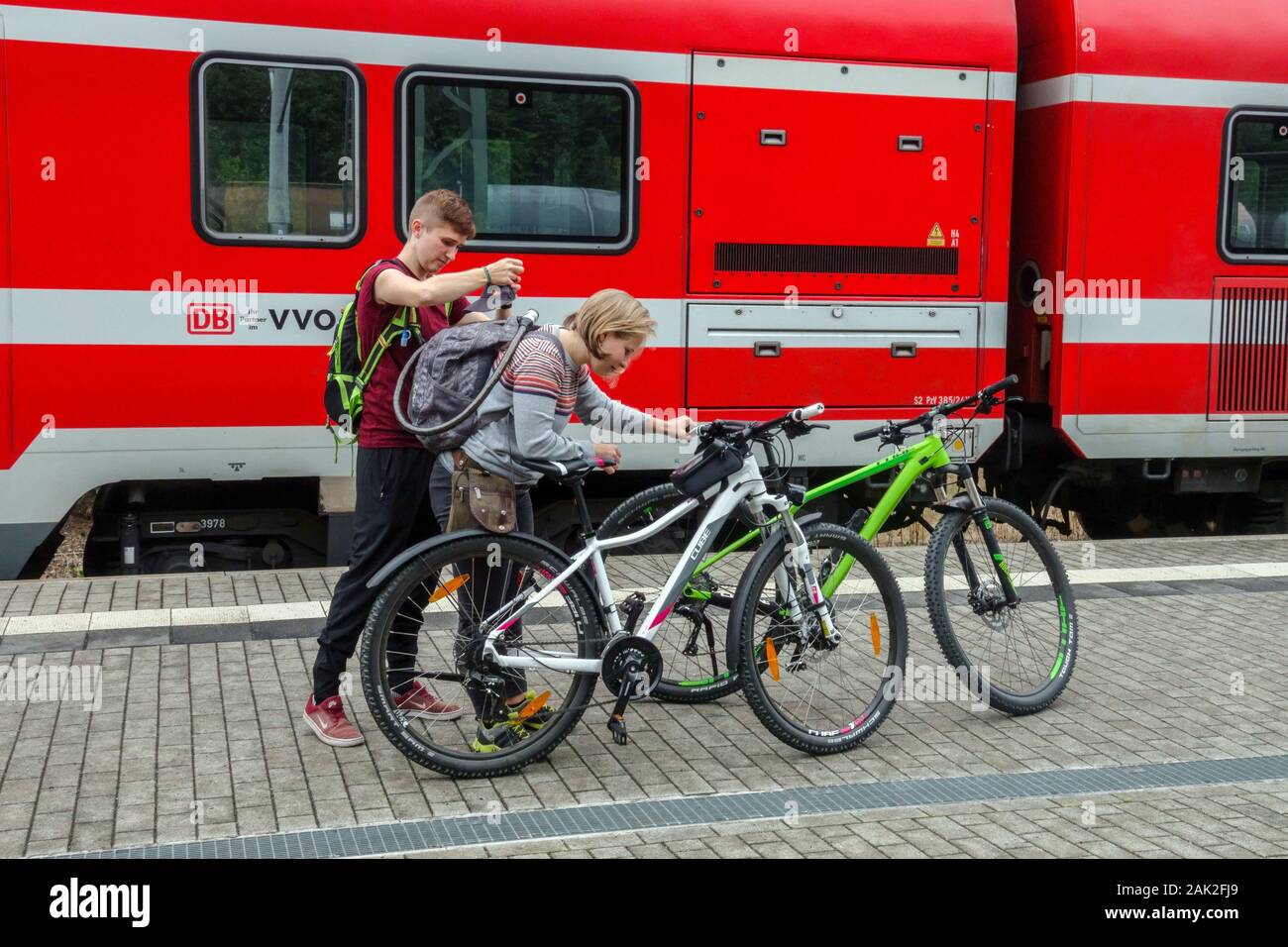 Two young German cyclist on bike trip Germany train people Stock Photo