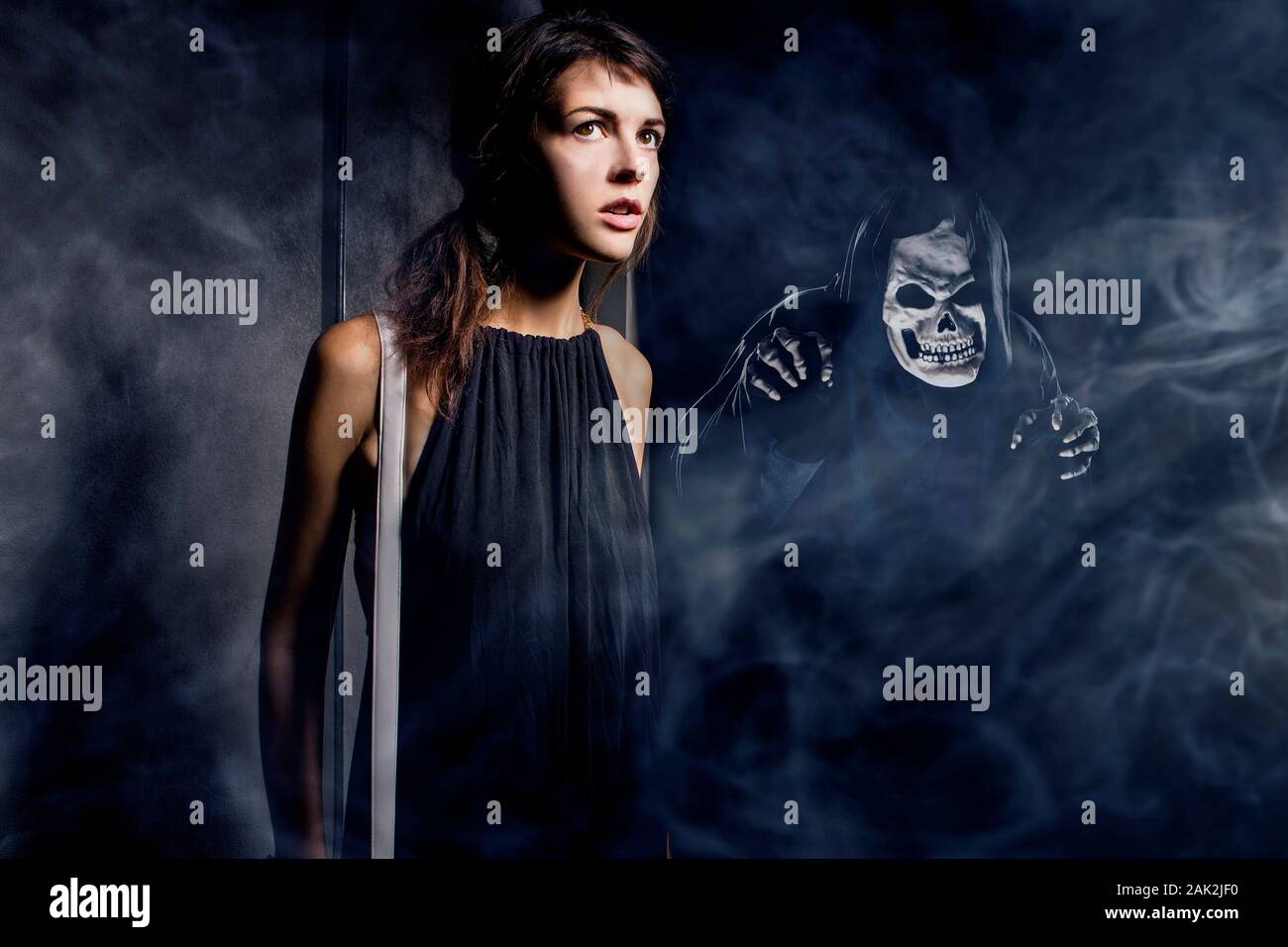 Woman in a dark alley with fog or mist imagining or seeing a demon or