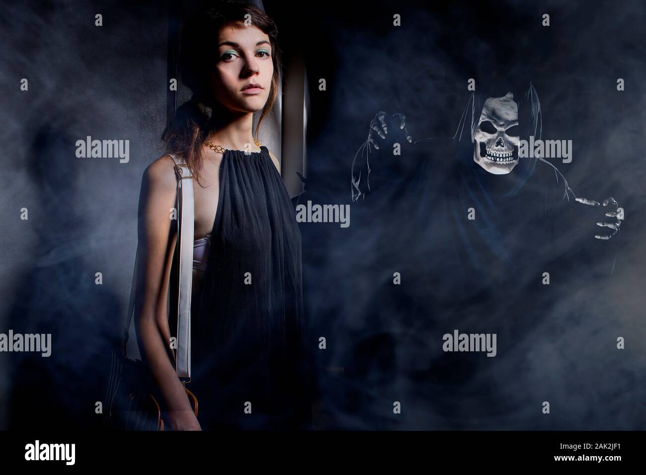 Woman in a dark alley with fog or mist imagining or seeing a demon or