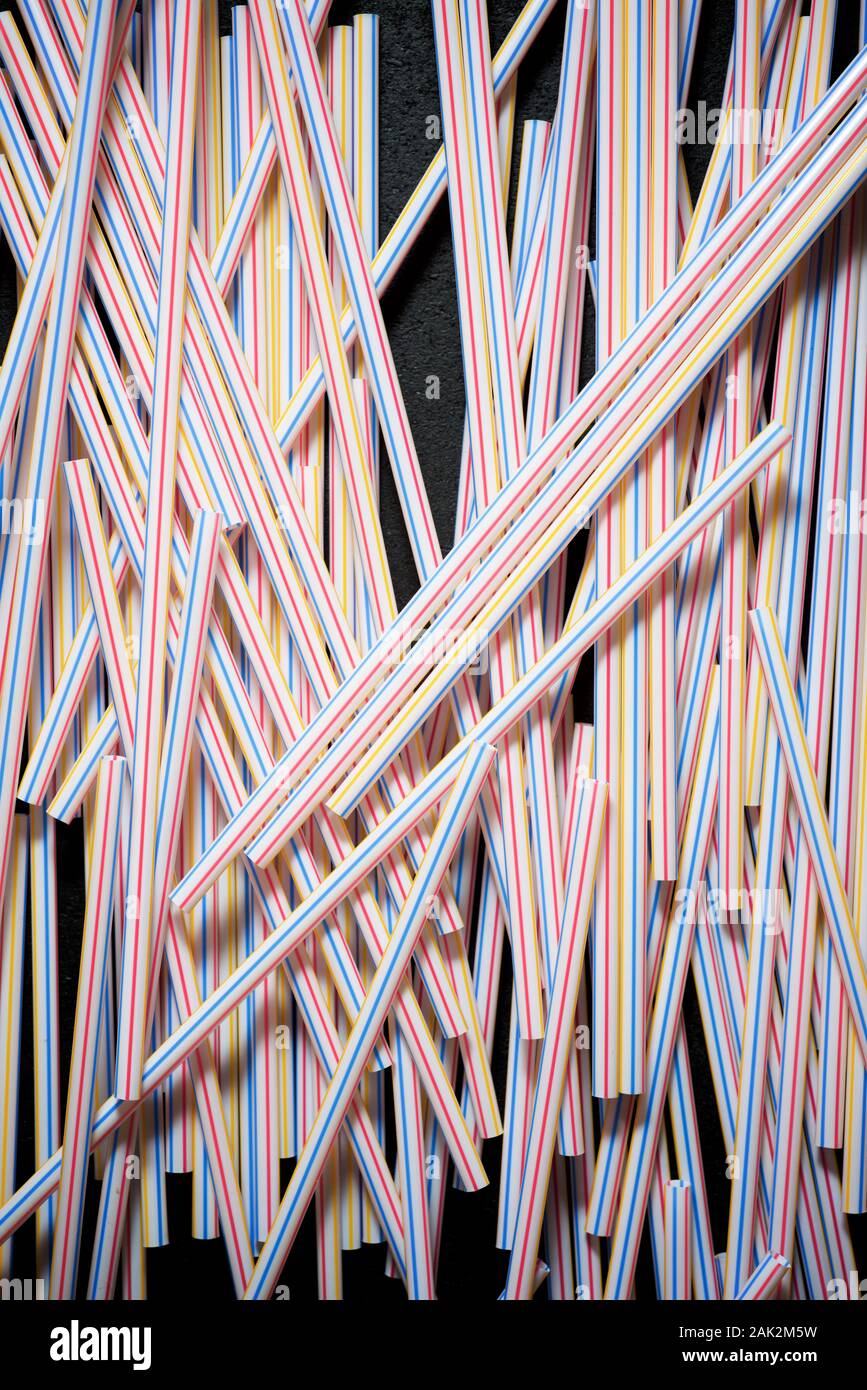 Drinking plastic straws on a black table. Stock Photo