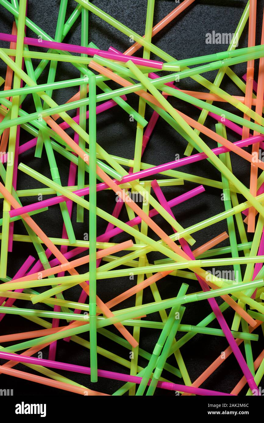 Drinking plastic straws on a black table. Stock Photo