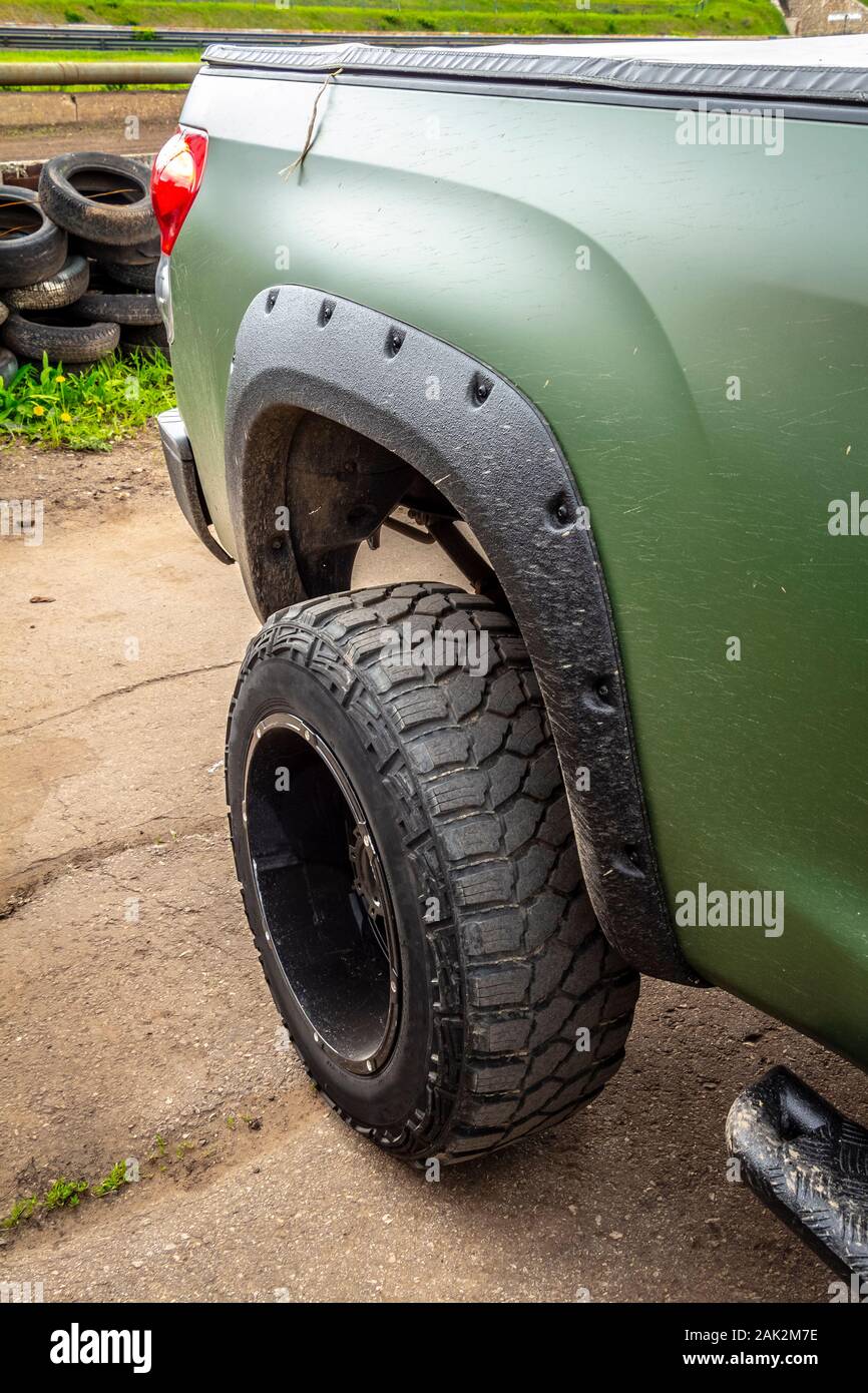 Wheel of green offroad pickup truck close-up Stock Photo - Alamy