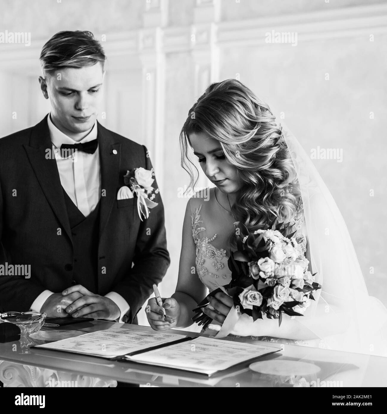 black and white photo. the bride and groom signing the marriage contract. Stock Photo
