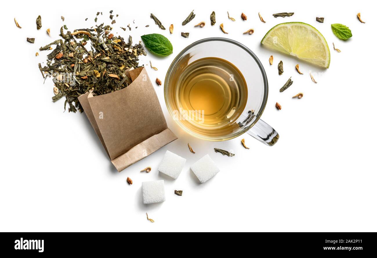 Green tea with natural aromatic additives and a cup. Top view on white ...
