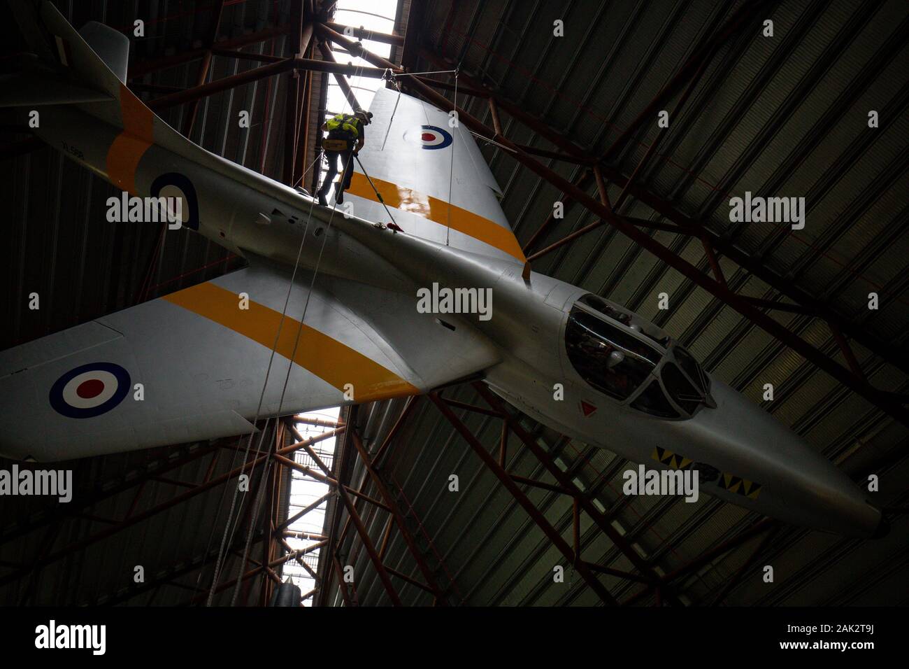 Specialist operators at the Royal Air Force Museum Cosford, near Telford, Shropshire, clean the suspended Hawker Hunter aircraft displayed within the museum's National Cold War Exhibition, during the annual high-level aircraft cleaning and maintenance. Stock Photo