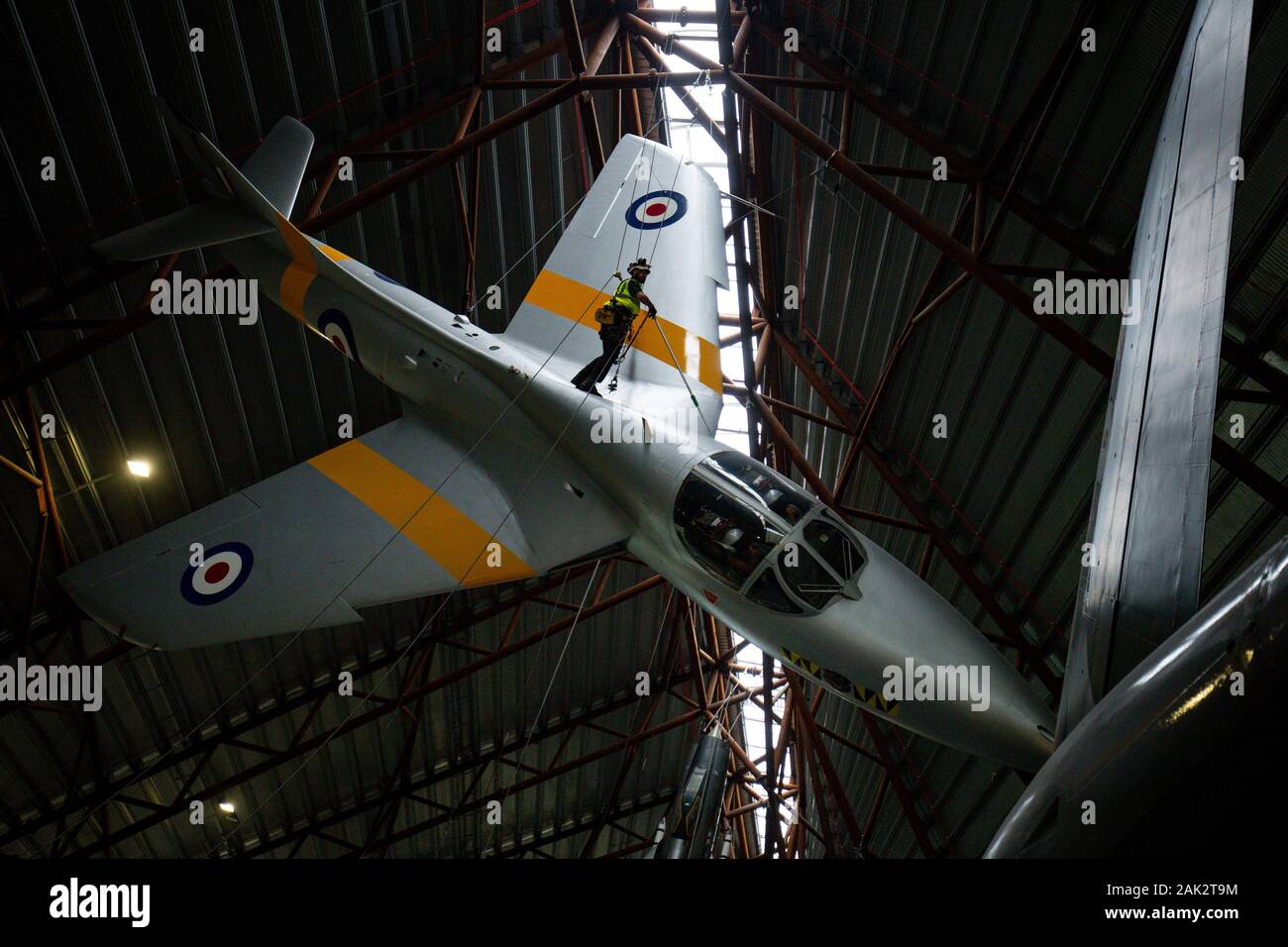 Specialist operators at the Royal Air Force Museum Cosford, near Telford, Shropshire, clean the suspended Hawker Hunter aircraft displayed within the museum's National Cold War Exhibition, during the annual high-level aircraft cleaning and maintenance. Stock Photo