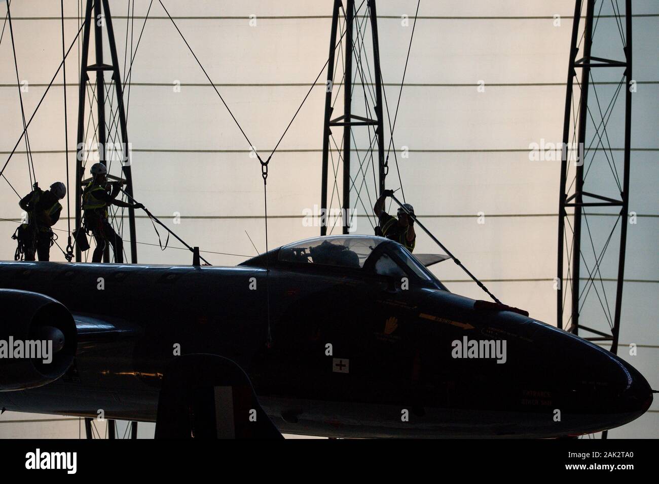 Specialist operators at the Royal Air Force Museum Cosford, near Telford, Shropshire, clean the suspended aircraft displayed within the museum's National Cold War Exhibition, during the annual high-level aircraft cleaning and maintenance. Stock Photo