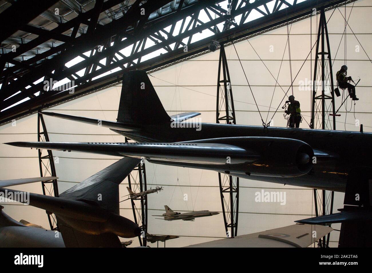 Specialist operators at the Royal Air Force Museum Cosford, near Telford, Shropshire, clean the suspended aircraft displayed within the museum's National Cold War Exhibition, during the annual high-level aircraft cleaning and maintenance. Stock Photo