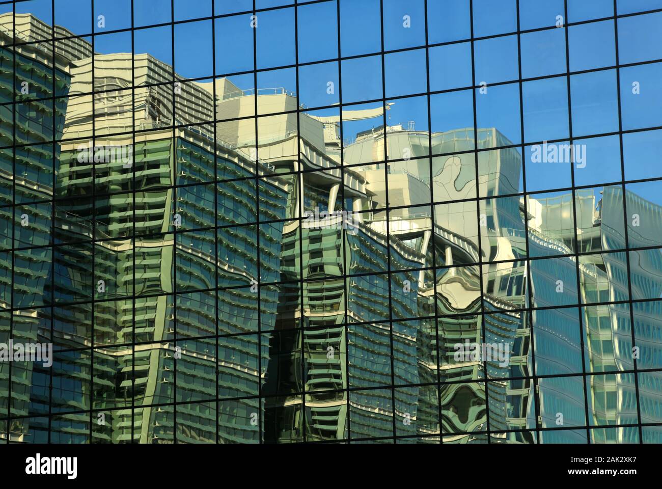 High-rise buildings reflected in glass sided building in Birmingham city centre, UK. Stock Photo