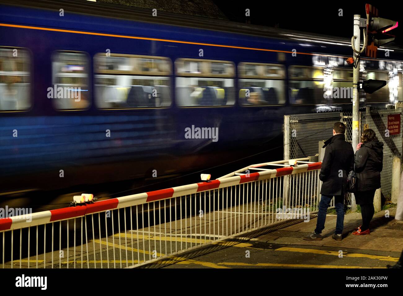 Modern replica steam engine in Lincoln station at night with enthusiast train. Stock Photo