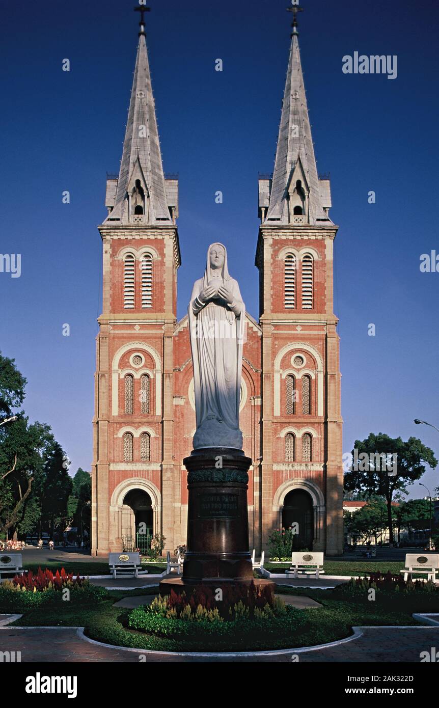 A statue of Saint Mary standing in front of the 1883 built Cathedral of Our Lady in Ho Chi Minh City that is the biggest city of Vietnam and is locate Stock Photo