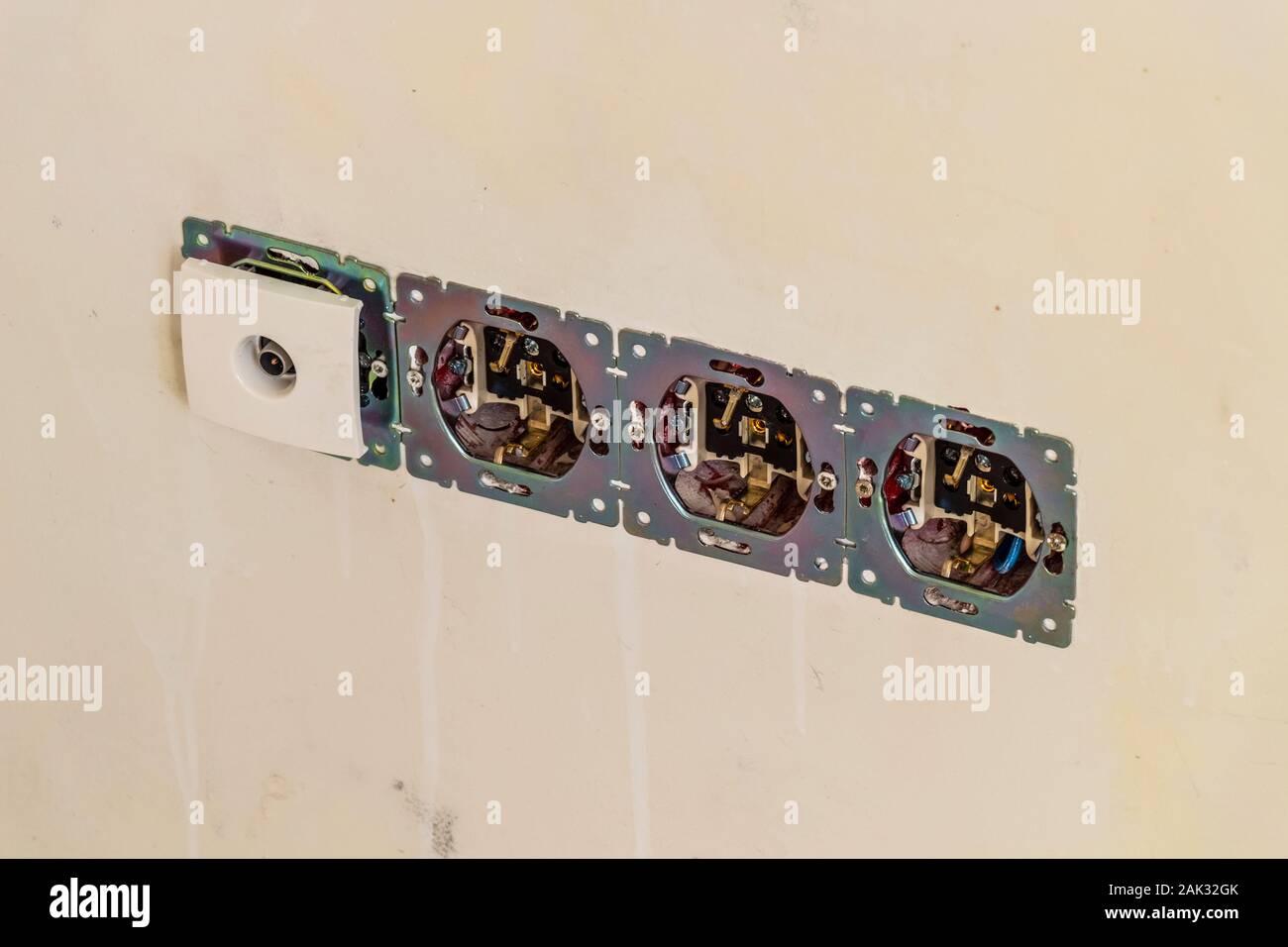 Installation of electrical outlets during construction work Stock Photo