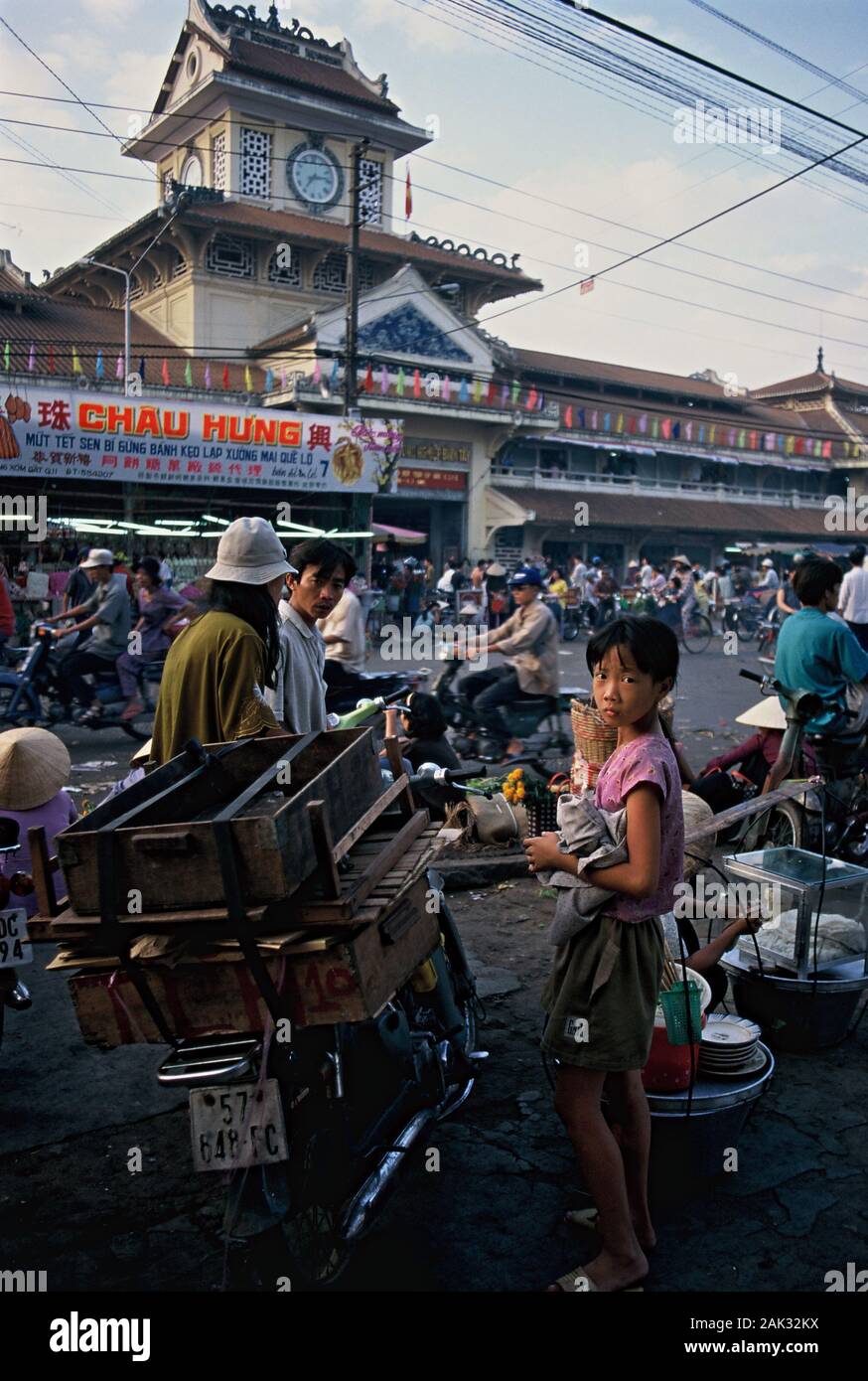 Crowds and cycles enliven the streets at Binh-Tay Market in Ho Chi Minh City that is the biggest city of Vietnam and is located in the south of the So Stock Photo