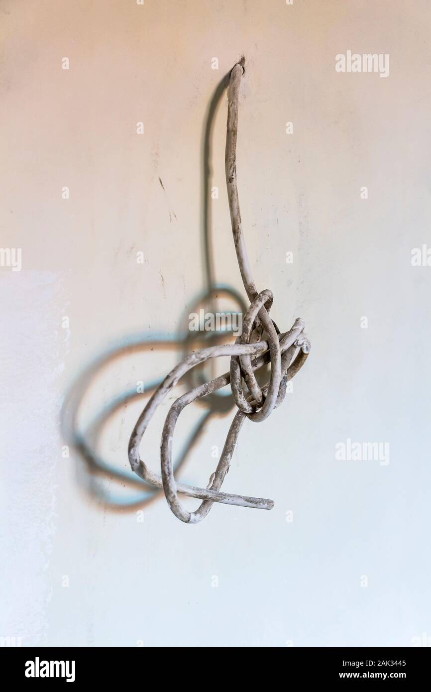 The wire sticks out of the wall during construction work Stock Photo - Alamy