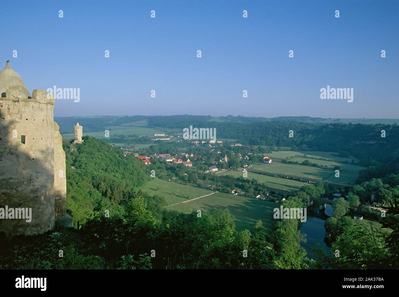 High above the village of Saaleck and the Saale river are the castle ruins of the Rudelsburg and the Saaleck Castle situated on forested hills. Saalec Stock Photo
