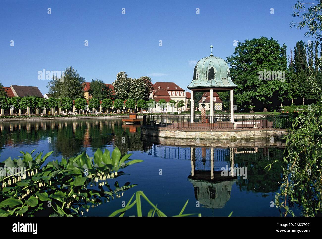 A historic alcove reflects in the water of the lake in Bad Lauchstaedt. The spa of Bad Lauchstaedt is located in the federal state of Saxony-Anhalt in Stock Photo