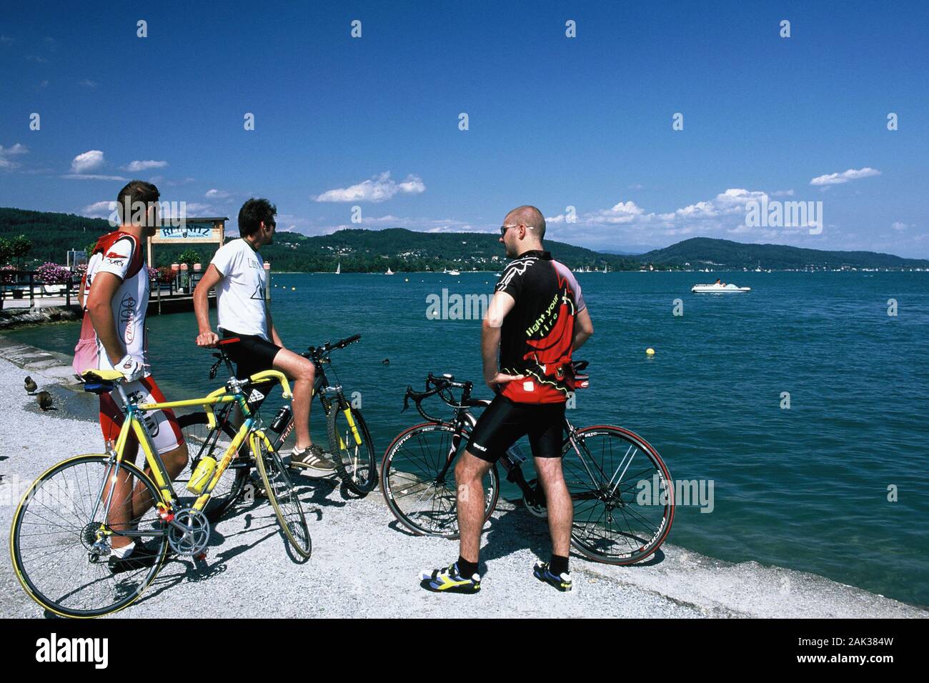 Cyclists in the town Reifnitz at the bank of lake Woerthersee, Austria.(undated picture) | usage worldwide Stock Photo
