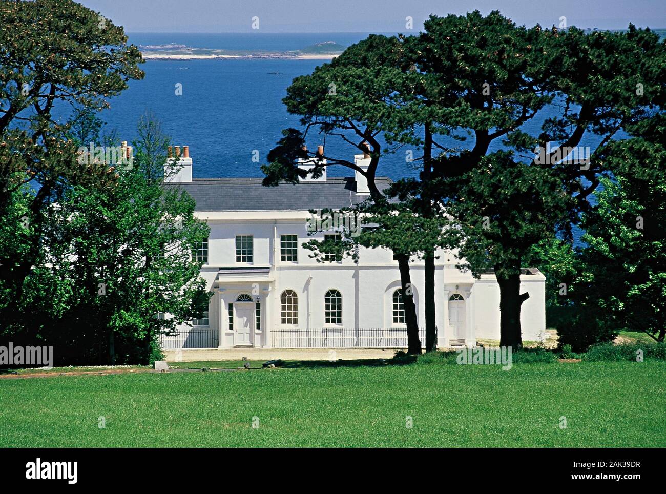 a-white-painted-mansion-stands-on-the-rise-of-fort-george-directly-at