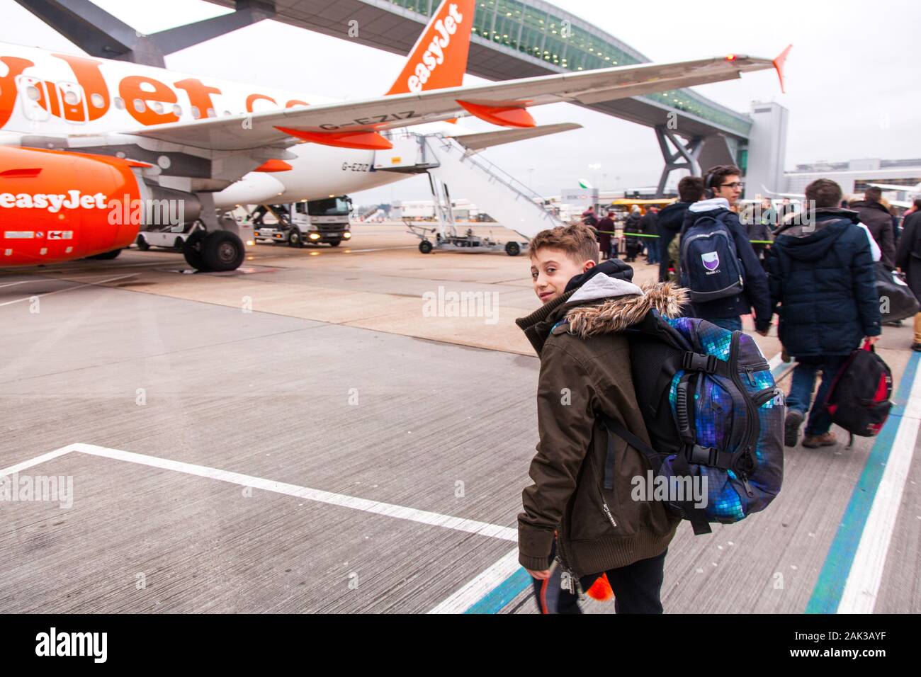 10 year old boy excitedly boarding a Easyjet flight at London Gatwick airport between London Gatwick LGW and Vienna Austria VIE Stock Photo
